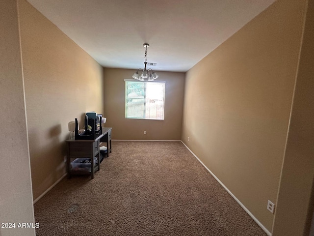 dining area with carpet flooring and a notable chandelier