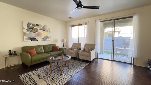 living room featuring dark hardwood / wood-style flooring and ceiling fan