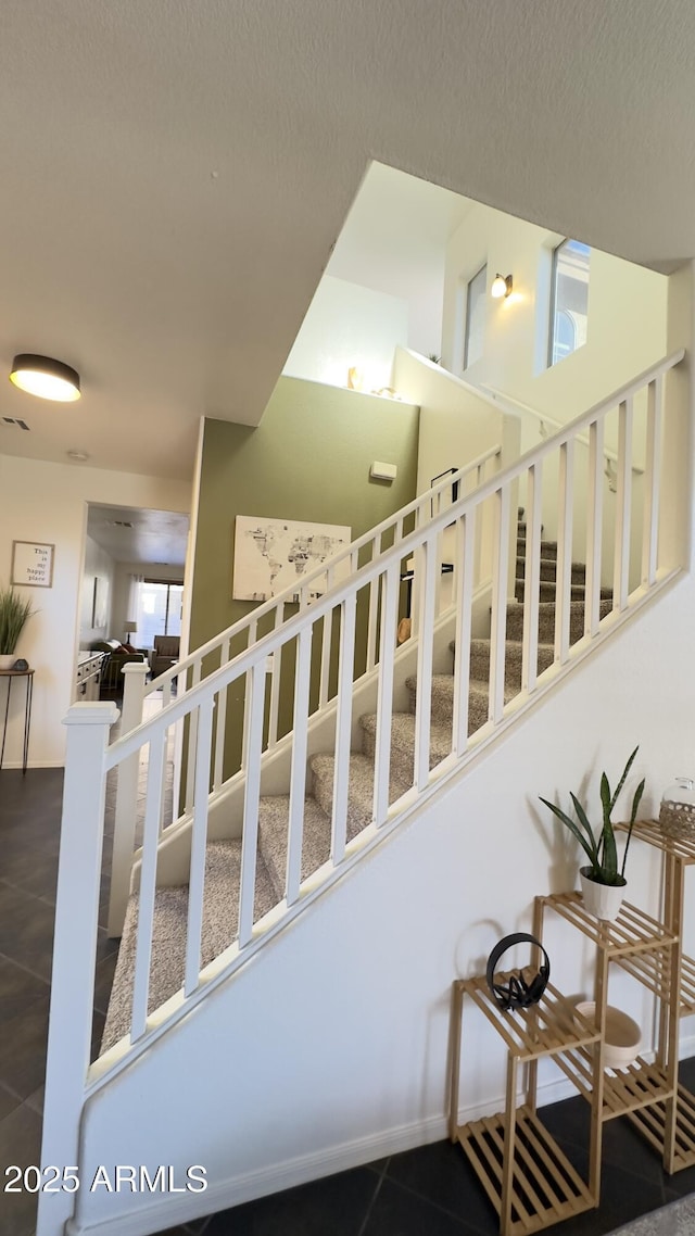 staircase with tile patterned flooring