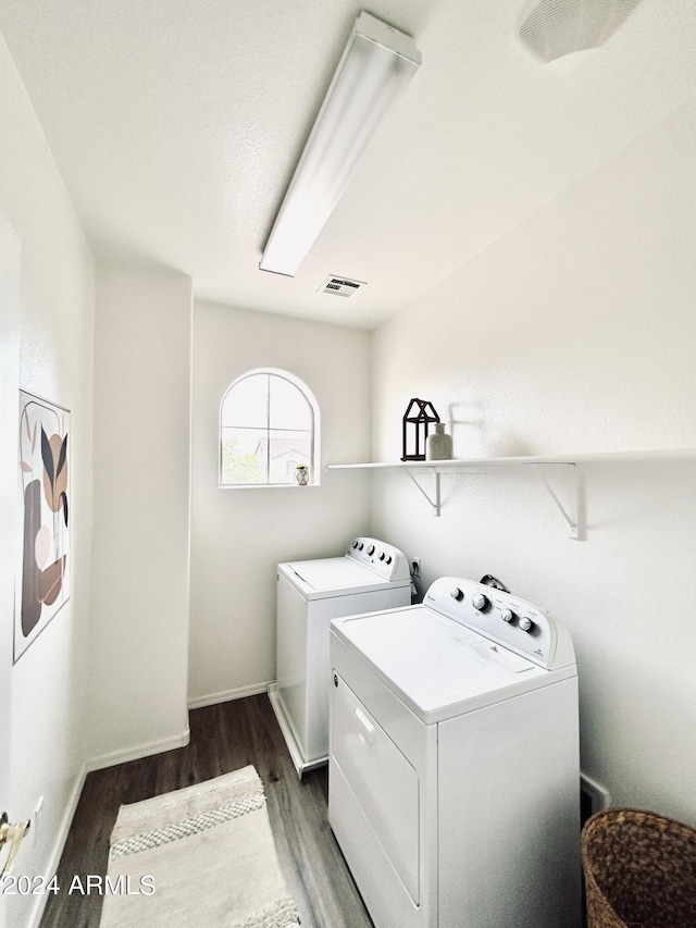 washroom featuring washing machine and dryer and dark hardwood / wood-style flooring