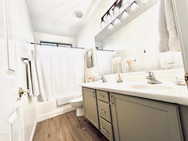 full bathroom featuring vanity, toilet, hardwood / wood-style floors, and shower / bath combo with shower curtain