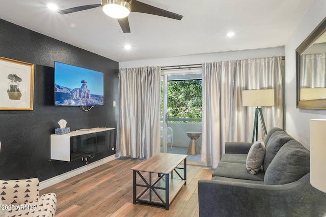 7625 E Camelback Rd Unit 310B, Scottsdale, AZ 85251 - living area with wood finished floors, a ceiling fan, recessed lighting, an accent wall, and baseboards