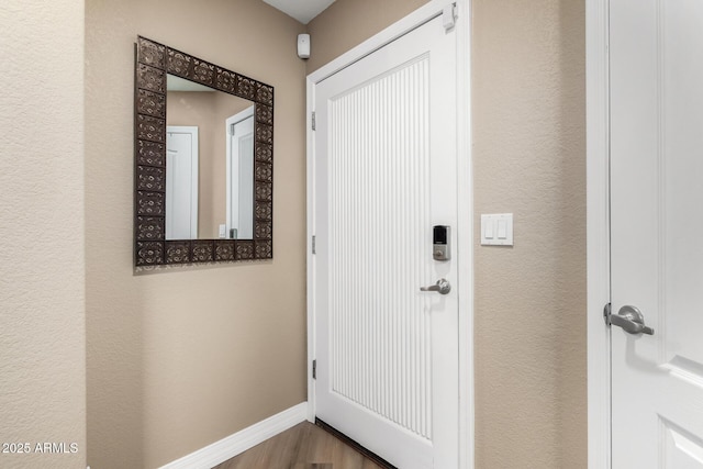 doorway with hardwood / wood-style flooring