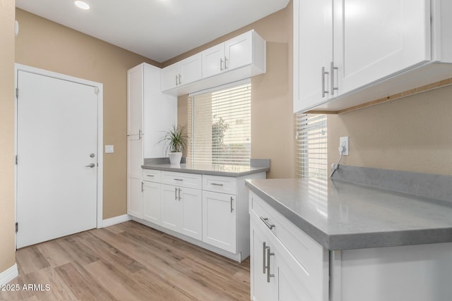 kitchen featuring white cabinetry and light wood-type flooring