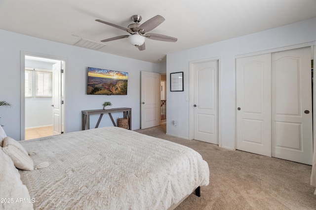 2331 E Sunland Ave, Phoenix, AZ 85040 - bedroom featuring two closets, light colored carpet, ensuite bath, ceiling fan, and baseboards