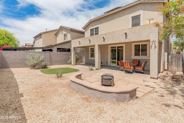 2331 E Sunland Ave, Phoenix, AZ 85040 - rear view of house with stucco siding, a fire pit, a patio area, and a fenced backyard