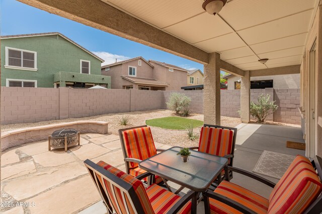 2331 E Sunland Ave, Phoenix, AZ 85040 - fenced backyard with a fire pit, a patio area, and outdoor dining area