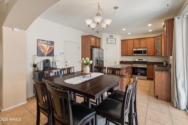 2331 E Sunland Ave, Phoenix, AZ 85040 - dining area with a chandelier, light tile patterned flooring, recessed lighting, arched walkways, and baseboards