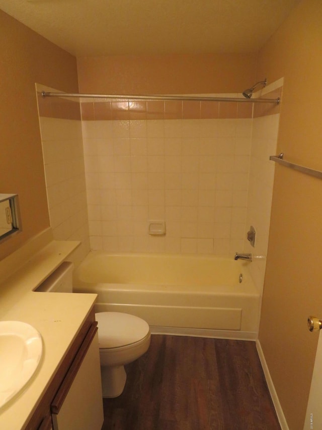 full bathroom with vanity, toilet, wood-type flooring, and tub / shower combination