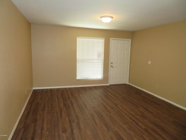 empty room featuring dark hardwood / wood-style flooring