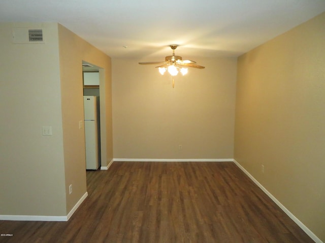 unfurnished room featuring ceiling fan and dark wood-type flooring