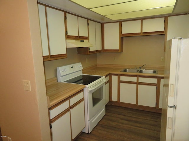 kitchen featuring white cabinetry, sink, dark wood-type flooring, and white appliances