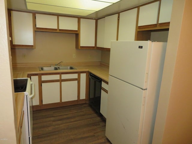 kitchen featuring dark hardwood / wood-style flooring, white cabinetry, sink, and white appliances