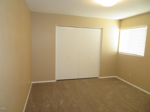 unfurnished bedroom featuring a closet and carpet floors