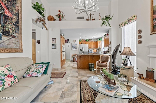 living room with a high ceiling and a chandelier