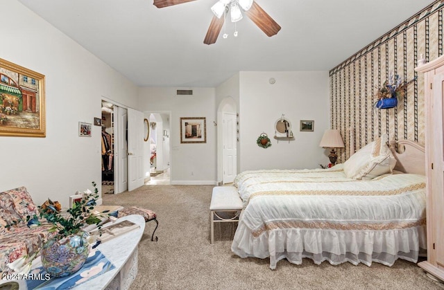 carpeted bedroom with ceiling fan and a closet