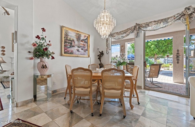 dining room featuring an inviting chandelier and lofted ceiling