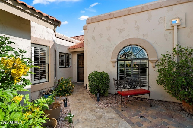 18780 N 94th Ave, Peoria, AZ 85382 - doorway to property with a tiled roof, stucco siding, and a patio area