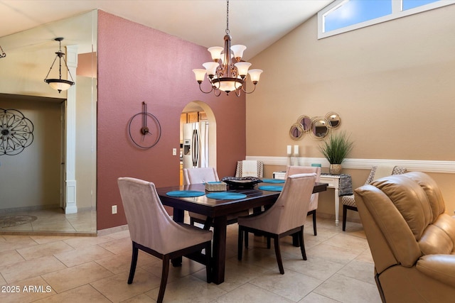 18780 N 94th Ave, Peoria, AZ 85382 - dining room featuring arched walkways, light tile patterned floors, high vaulted ceiling, and a chandelier