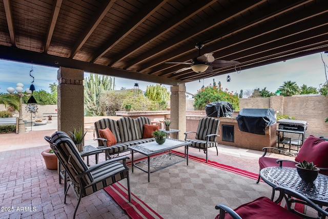 view of patio featuring an outdoor living space, area for grilling, an outdoor kitchen, and ceiling fan