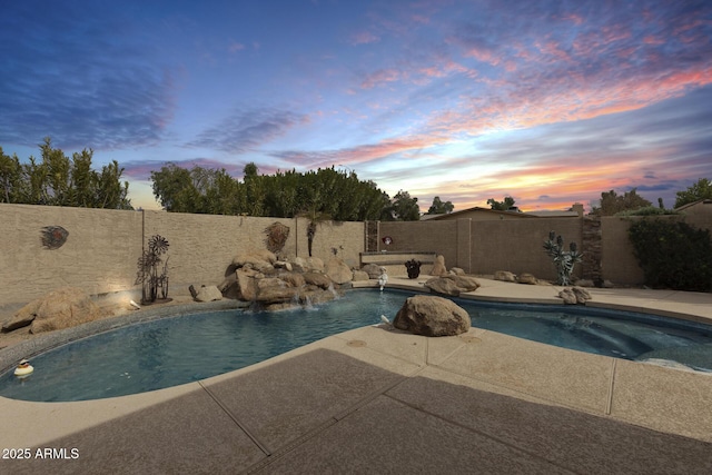 view of pool at dusk