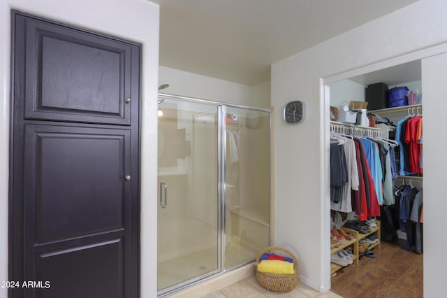 bathroom featuring a shower with shower door