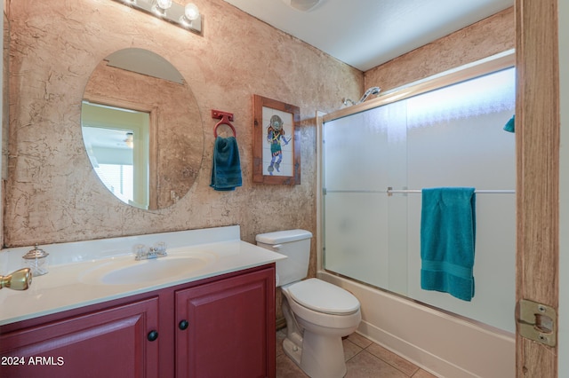 full bathroom featuring enclosed tub / shower combo, vanity, toilet, and tile patterned floors