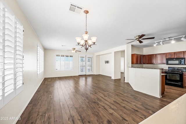 kitchen featuring black appliances, ceiling fan with notable chandelier, rail lighting, decorative light fixtures, and dark hardwood / wood-style flooring