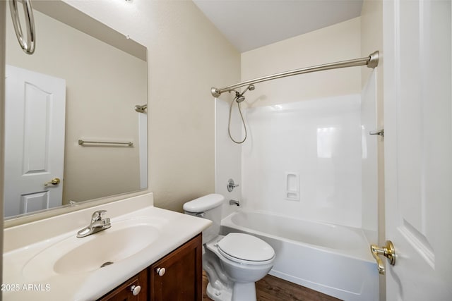 full bath with wood finished floors, toilet, vanity, and washtub / shower combination