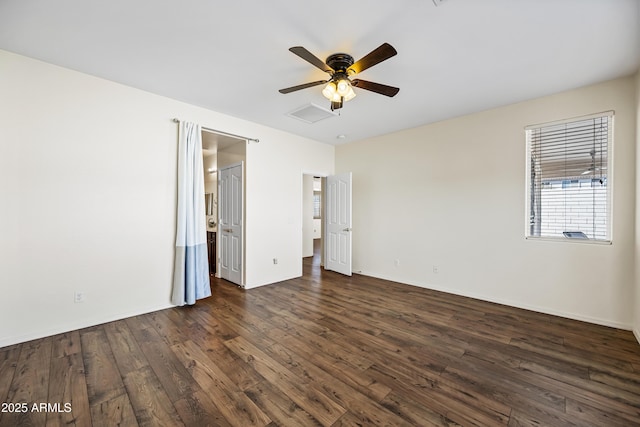 empty room with baseboards, dark wood-style floors, visible vents, and ceiling fan