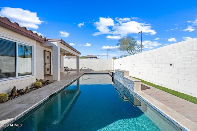 view of swimming pool with a patio area