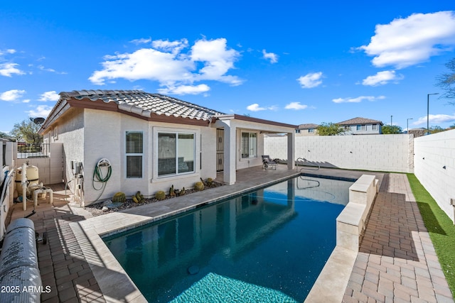 view of pool featuring a patio area, a fenced in pool, and a fenced backyard