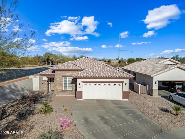 single story home with a tiled roof, concrete driveway, stucco siding, a garage, and stone siding