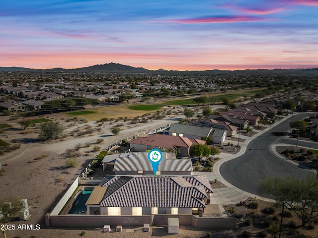 aerial view at dusk featuring a mountain view