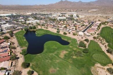 aerial view with a water and mountain view and view of golf course