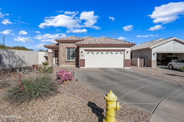 view of front of home with fence, stucco siding, a garage, stone siding, and a tiled roof