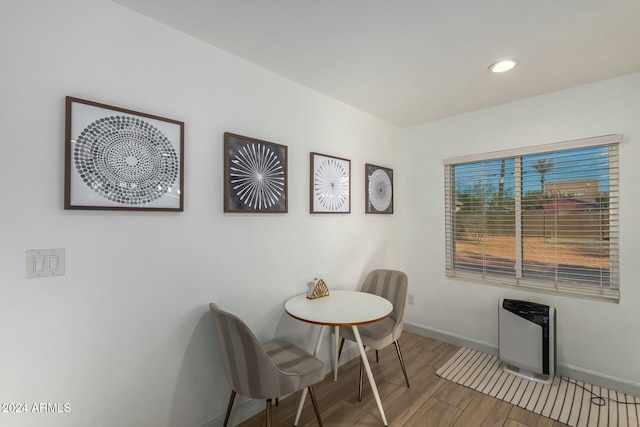 living area featuring hardwood / wood-style floors and heating unit