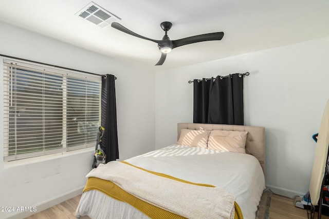 bedroom with ceiling fan and light hardwood / wood-style floors