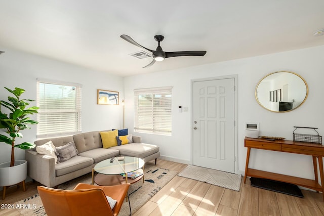 living room featuring light hardwood / wood-style flooring and ceiling fan