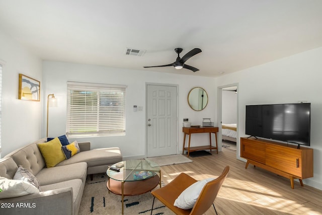 living room featuring ceiling fan and light hardwood / wood-style flooring