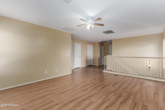 spare room with ceiling fan and light hardwood / wood-style flooring