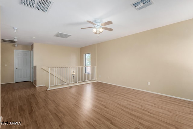 unfurnished room with wood-type flooring and ceiling fan