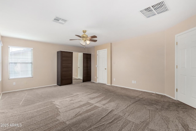 empty room with light colored carpet and ceiling fan