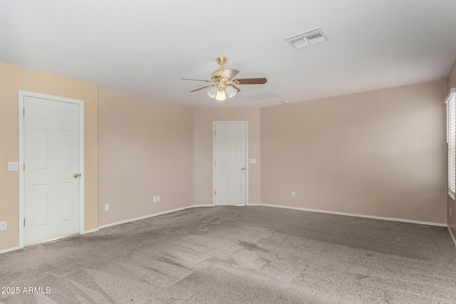 empty room with ceiling fan and carpet flooring