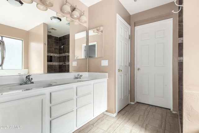 bathroom featuring vanity and tiled shower