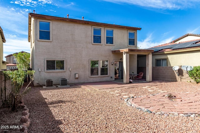 rear view of house featuring central AC and a patio