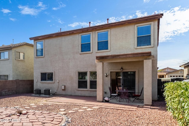 rear view of property featuring central AC and a patio