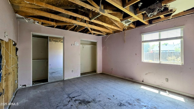 unfurnished bedroom featuring two closets