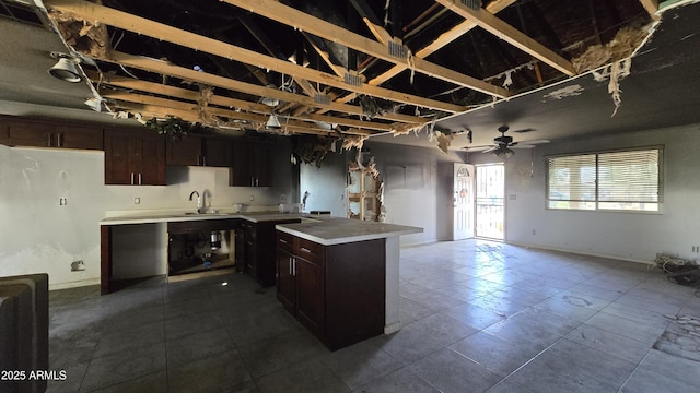kitchen featuring a peninsula, light countertops, a ceiling fan, and open floor plan
