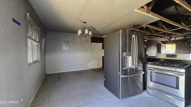 kitchen featuring baseboards, tile patterned floors, stainless steel appliances, and a chandelier